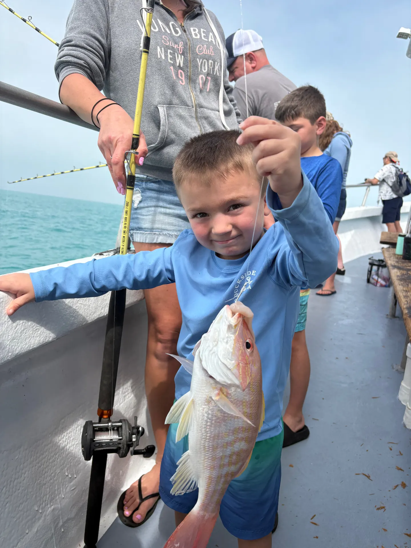 Young angler proudly holding up a bright lane snapper caught aboard the Gulfstream party boat off Key West, January 2026.