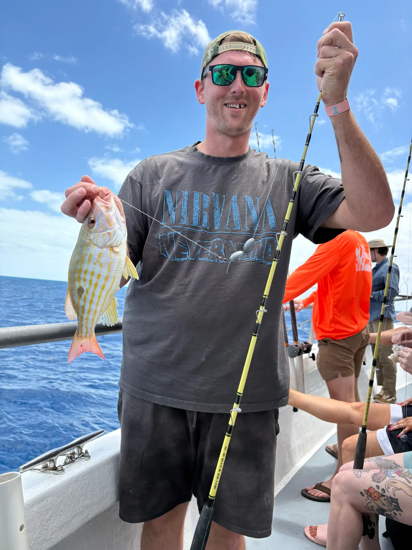 Angler holding a bright lane snapper caught on the Gulfstream party boat off Key West, March 12, 2026.