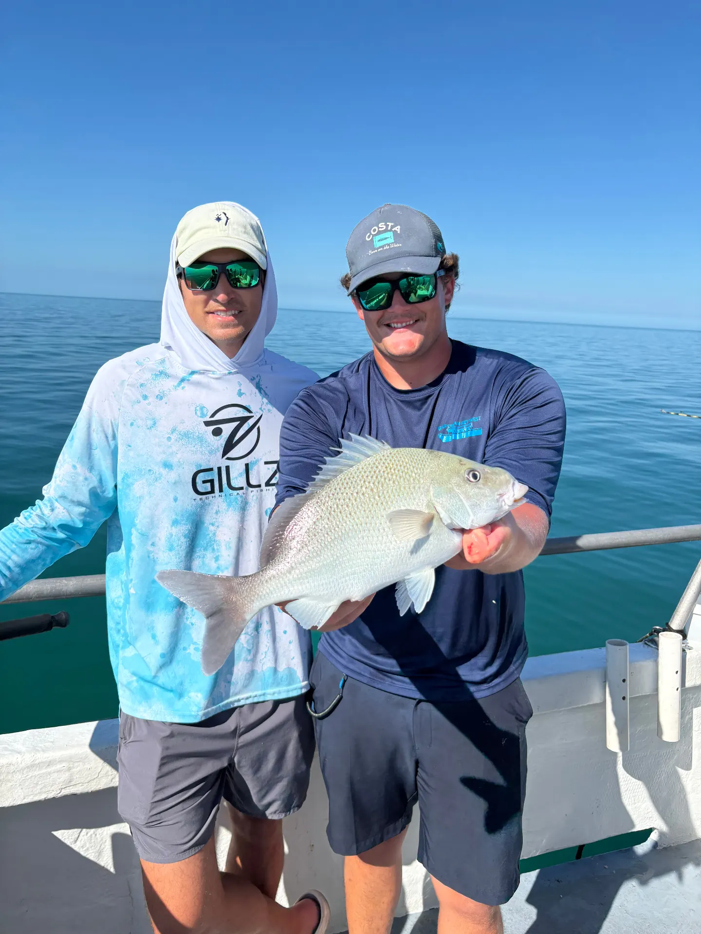 Happy anglers holding fresh caught porgy on Gulfstream party boat Key West Florida