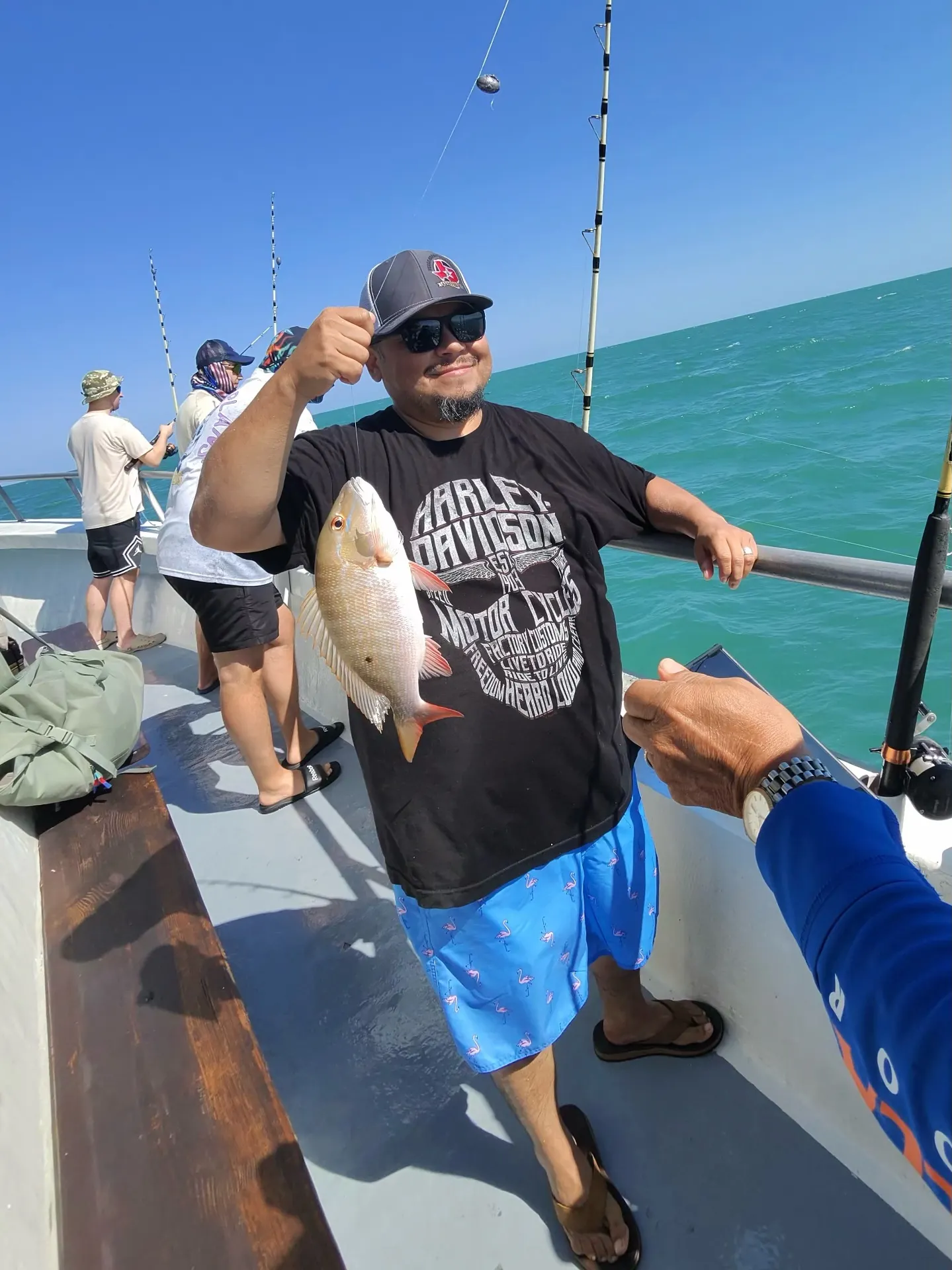 Excited fisherman with mutton snapper catch on Gulfstream fishing charter Key West