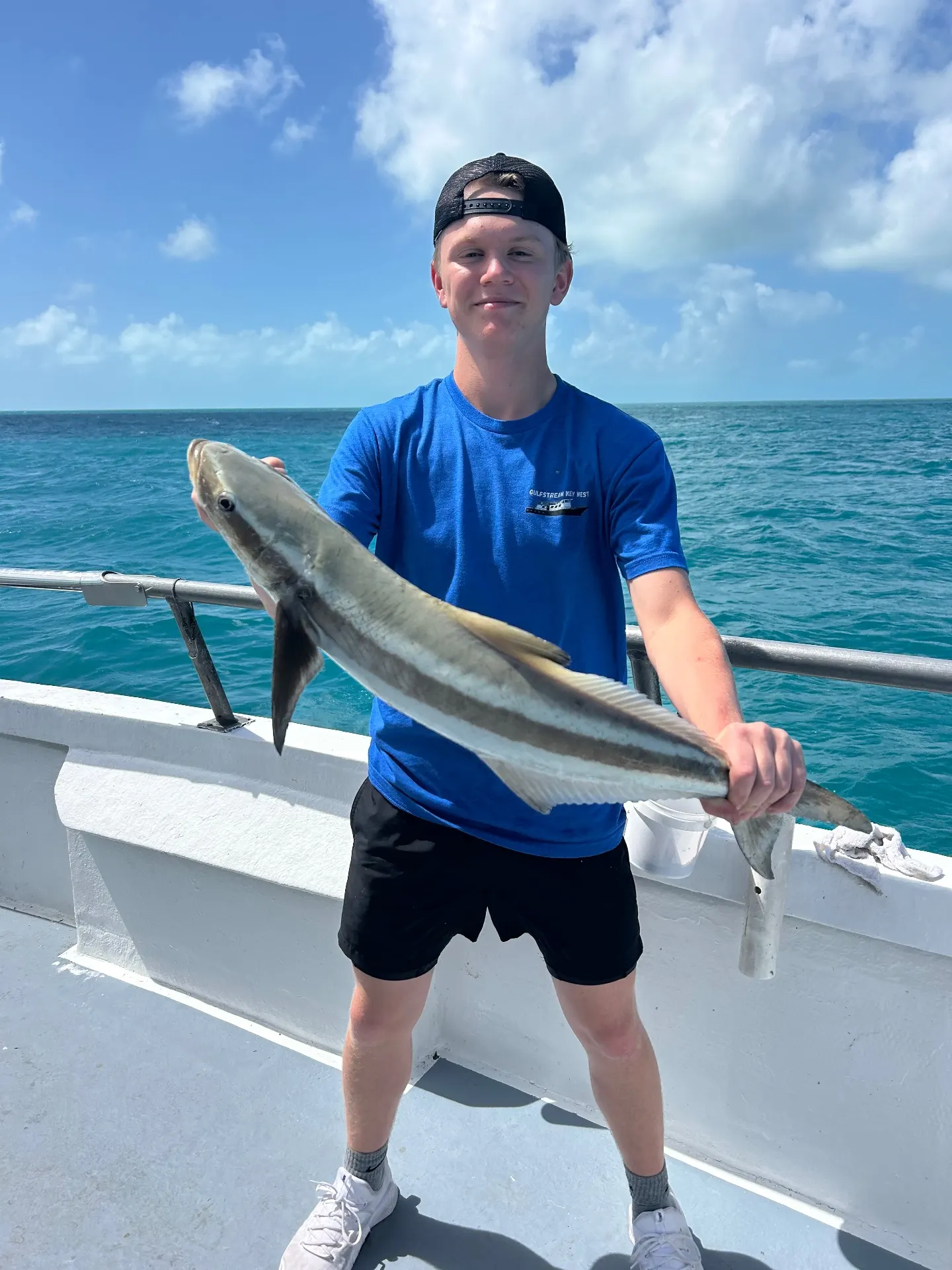 Young angler holding a nice cobia caught aboard the Gulfstream party boat off Key West, November 24, 2025.