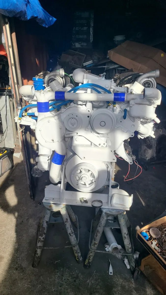 A Gulfstream replacement engine on jack stands in the shop, painted white with blue couplers, September 2026.
